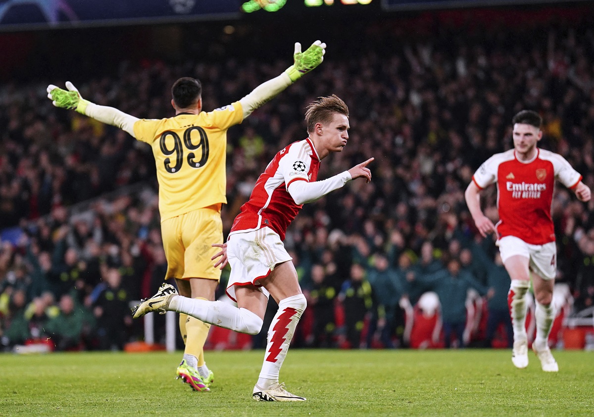 Arsenal's Martin Odegaard, center, celebrates scoring before his goal is then disallowed during the Champions League round of 16, second leg soccer match between Arsenal and Porto at the Emirates Stadium, London, Tuesday March 12, 2024. (Zac Goodwin/PA via AP)