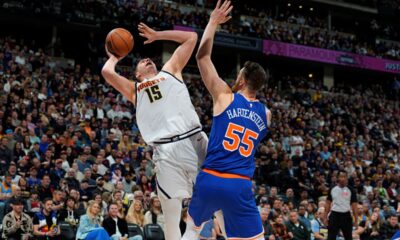 Denver Nuggets center Nikola Jokic (15) is fouled while going up for a basket by New York Knicks center Isaiah Hartenstein (55) in the second half of an NBA basketball game Thursday, March 21, 2024, in Denver. (AP Photo/David Zalubowski)