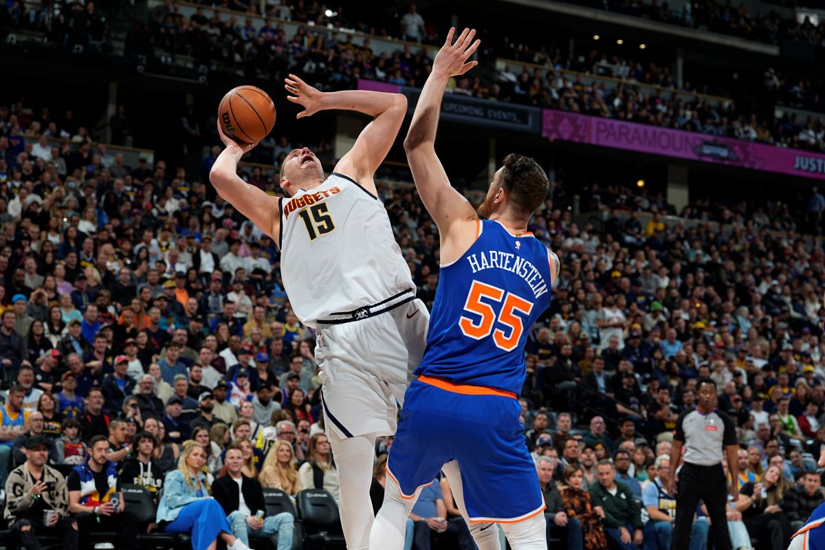 Denver Nuggets center Nikola Jokic (15) is fouled while going up for a basket by New York Knicks center Isaiah Hartenstein (55) in the second half of an NBA basketball game Thursday, March 21, 2024, in Denver. (AP Photo/David Zalubowski)