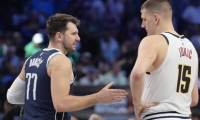 Dallas Mavericks guard Luka Doncic (77) offers his hand to shake with Denver Nuggets center Nikola Jokic (15) before the start of the first half of an NBA basketball game in Dallas, Sunday, March 17, 2024. (AP Photo/LM Otero)