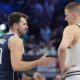 Dallas Mavericks guard Luka Doncic (77) offers his hand to shake with Denver Nuggets center Nikola Jokic (15) before the start of the first half of an NBA basketball game in Dallas, Sunday, March 17, 2024. (AP Photo/LM Otero)