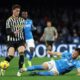Juventus's Dusan Vlahovic, centre left, and Napoli's Amir Rrahmani challenge for the ball during the Serie A soccer match between Napoli and Juventus at the Diego Armando Maradona stadium in Naples, Italy, Sunday, March 3, 2024. (Alessandro Garofalo/LaPresse via AP)