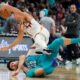 Phoenix Suns guard Grayson Allen, top, and Charlotte Hornets guard Vasa Micic collide during the second half of an NBA basketball game on Friday, March 15, 2024, in Charlotte, N.C. (AP Photo/Chris Carlson)