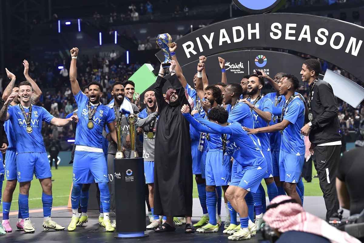 Al Hilal players celebrate the trophy of Riyadh Season Cup 2024 at Kingdom Arena Stadium in Riyadh, Saudi Arabia, on Feb. 8, 2024. Saudi Arabian soccer club Al Hilal will target a 28th straight win in competitive games Tuesday, March 12, 2024, that would set a world record for a top-tier team. Fueled by Serbia forward Aleksandar Mitrović’s goals during Neymar’s long-term injury, Al Hilal aims for the record-setting win in a second-leg game in the Asian Champions League quarterfinals against domestic rival Al Ittihad. (AP Photo)