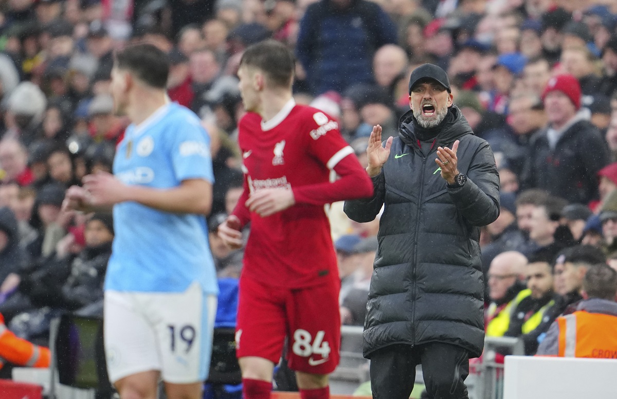 Liverpool's manager Jurgen Klopp instructs his players during the English Premier League soccer match between Liverpool and Manchester City, at Anfield stadium in Liverpool, England, Sunday, March 10, 2024. (AP Photo/Jon Super)