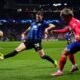 Atletico Madrid's Antoine Griezmann, right, passes the ball past Inter Milan's Benjamin Pavard during the Champions League, round of 16, second leg soccer match between Atletico Madrid and Inter Milan at the Metropolitano stadium in Madrid, Spain, Wednesday, March 13, 2024. (AP Photo/Manu Fernandez)