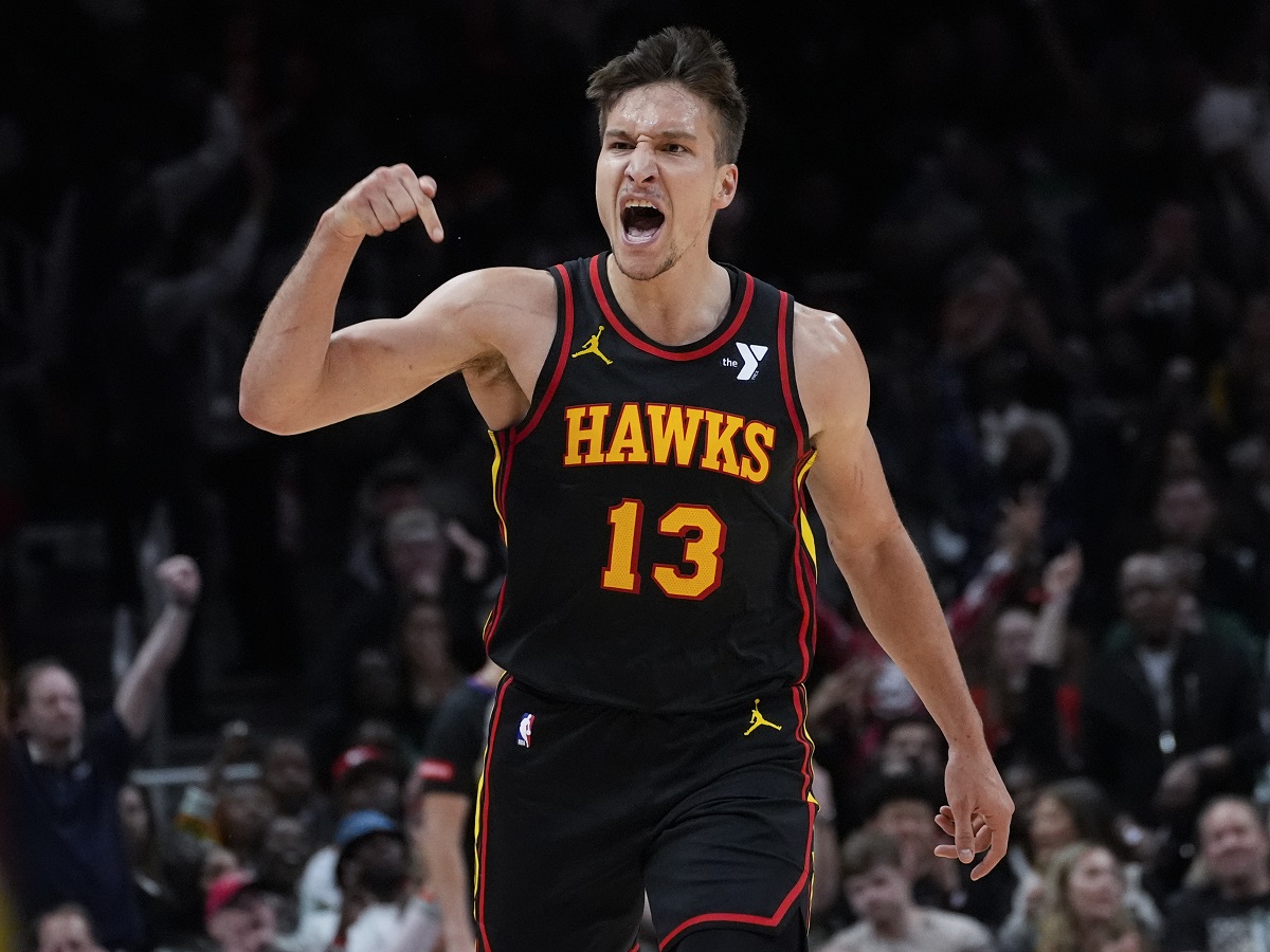 Atlanta Hawks guard Bogdan Bogdanovic (13) reacts after a basket during the second half of an NBA basketball game against the Boston Celtics Thursday, March 28, 2024, in Atlanta. (AP Photo/John Bazemore)