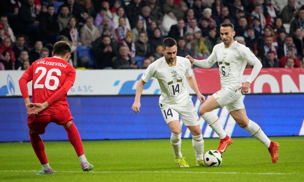 Serbia's Andrija Zivkovic, centre, and Serbia's Milan Gajic, right, in action against Russia's Daniil Khlusevich during an international friendly soccer match between Russia and Serbia at the Central Dynamo Stadium of Lev Yashin in Moscow, Russia, Thursday, March 21, 2024. (AP Photo/Alexander Zemlianichenko)