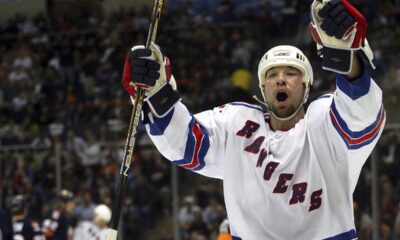 FILE - New York Rangers' Chris Simon celebrates his second-period goal against the New York Islanders, Thursday, Feb. 26, 2004, at Nassau Coliseum in Uniondale, N.Y. Former NHL enforcer Chris Simon has died. He was 52. Simon died Monday night, March 18, 2024, according to a spokesperson for the NHL Players' Association. (AP Photo/Ed Betz, File)