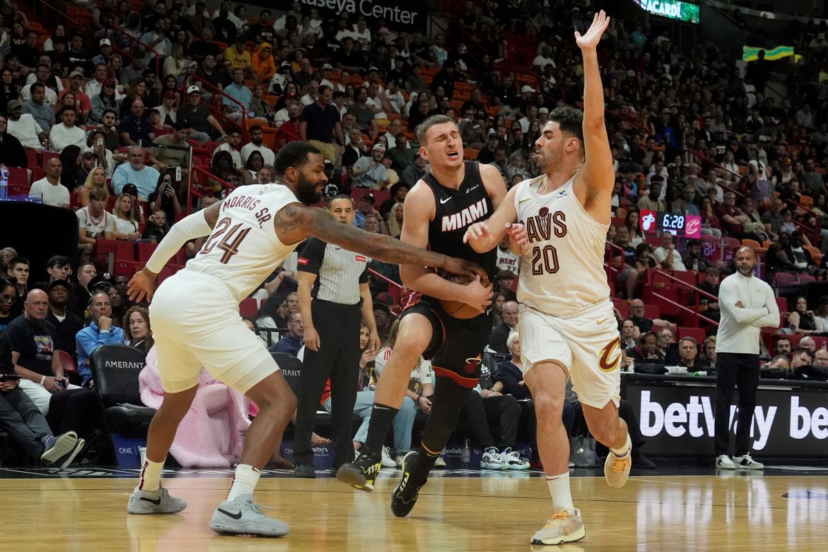 Cleveland Cavaliers forward Marcus Morris Sr. (24) and forward Georges Niang (20) defend Miami Heat forward Nikola Jovic (5) during the second half of an NBA basketball game, Sunday, March 24, 2024, in Miami. (AP Photo/Marta Lavandier)