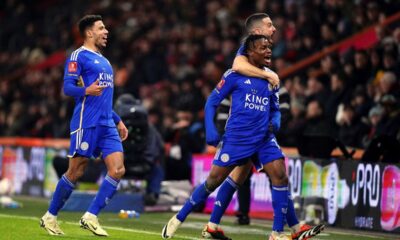 Leicester City's Abdul Fatawu, right, celebrates with Conor Coady and and James Justin, left, after scoring the opening goal during the FA Cup 5th round soccer match at the Vitality stadium in Bournemouth, England, Tuesday, Feb. 27, 2024. (John Walton/PA via AP)