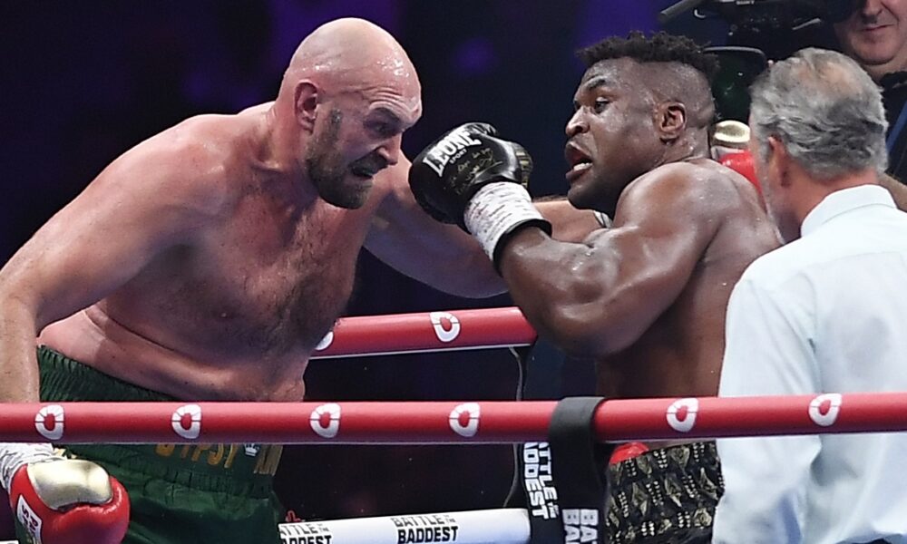 FILE - Tyson Fury, left, fights with Francis Ngannou, right, during their boxing fight in Riyadh, Saudi Arabia, Sunday, Oct. 29, 2023. Former UFC champion Francis Ngannou has already made a dramatic entry into the world of boxing by knocking down Tyson Fury in his first ever fight and taking the world heavyweight champion the distance. Now Ngannou is getting another shot at a high-profile heavyweight when he takes on Anthony Joshua back in Saudi Arabia. (AP Photo/Yazeed Aldhawaihi, File)