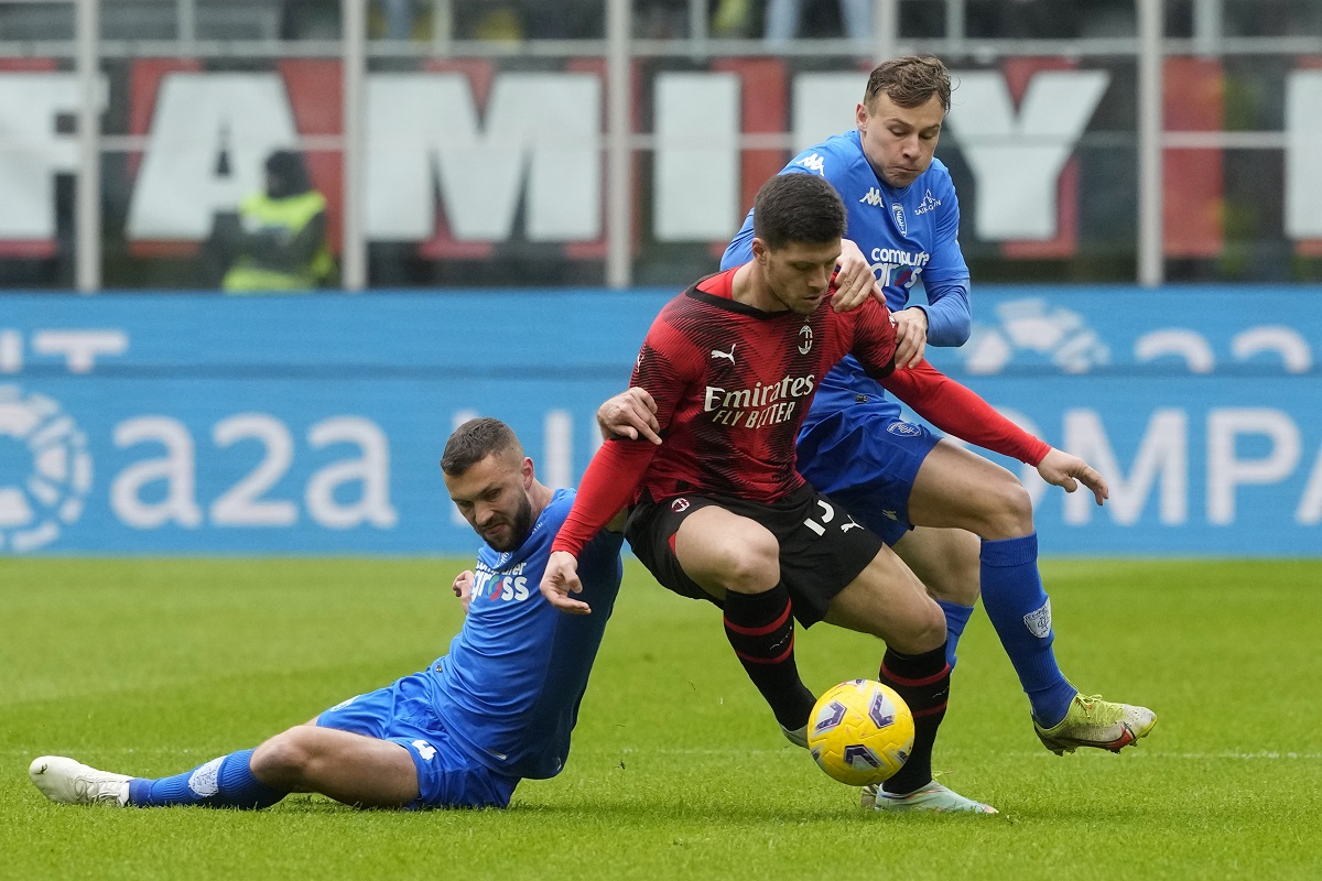 AC Milan's Luka Jovic, centre, challenges for the ball with Empoli's Sebastian Walukiewicz, left, and Empoli's Szymon Zurkowski during a Serie A soccer match between AC Milan and Empoli at the San Siro stadium in Milan, Italy, Sunday, March 10, 2024. (AP Photo/Luca Bruno)
