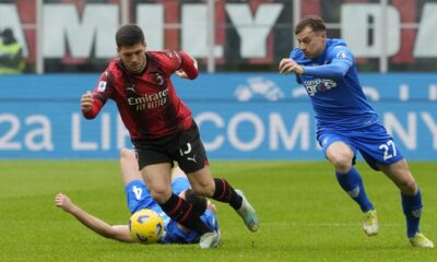 AC Milan's Luka Jovic, centre, dribbles past Empoli's Sebastian Walukiewicz, left, and Empoli's Szymon Zurkowski during a Serie A soccer match between AC Milan and Empoli at the San Siro stadium in Milan, Italy, Sunday, March 10, 2024. (AP Photo/Luca Bruno)