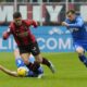 AC Milan's Luka Jovic, centre, dribbles past Empoli's Sebastian Walukiewicz, left, and Empoli's Szymon Zurkowski during a Serie A soccer match between AC Milan and Empoli at the San Siro stadium in Milan, Italy, Sunday, March 10, 2024. (AP Photo/Luca Bruno)