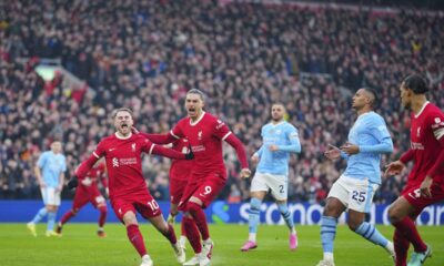 Liverpool's Alexis Mac Allister, left, celebrates after scoring a penalty, his side's first goal during the English Premier League soccer match between Liverpool and Manchester City, at Anfield stadium in Liverpool, England, Sunday, March 10, 2024. (AP Photo/Jon Super)