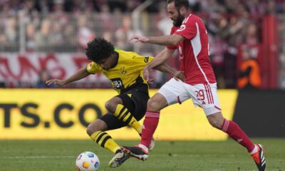 Dortmund's Karim Adeyemi, left, and Union's Lucas Tousart challenge for the ball during the German Bundesliga soccer match between 1. FC Union Berlin and Borussia Dortmund in Berlin, Germany, March 2, 2024. (AP Photo/Ebrahim Noroozi)