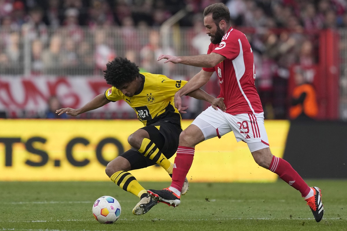 Dortmund's Karim Adeyemi, left, and Union's Lucas Tousart challenge for the ball during the German Bundesliga soccer match between 1. FC Union Berlin and Borussia Dortmund in Berlin, Germany, March 2, 2024. (AP Photo/Ebrahim Noroozi)