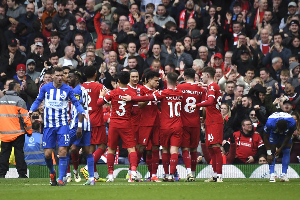 Liverpool players celebrate after Liverpool's Mohamed Salah scored his side's second goal during the English Premier League soccer match between Liverpool and Brighton and Hove at Anfield Stadium in Liverpool, England, Sunday, March 31, 2024. (AP Photo/Rui Vieira)