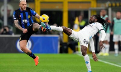 Inter Milan's Federico Dimarco vies for the ball with Napoli's Andre-Frank Zambo Anguissa, right, during the Serie A soccer match between Inter Milan and Napoli at the San Siro Stadium, in Milan, Italy, Sunday, March 17, 2024. (AP Photo/Antonio Calanni)