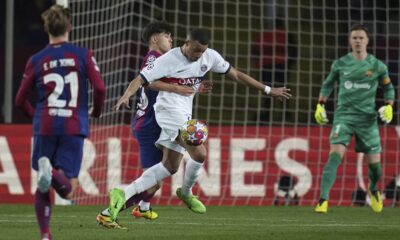 PSG's Kylian Mbappe, right, is challenged by Barcelona's Pau Cubarsi during the Champions League quarterfinal second leg soccer match between Barcelona and Paris Saint-Germain at the Olimpic Lluis Companys stadium in Barcelona, Spain, Tuesday, April 16, 2024. (AP Photo/Emilio Morenatti)
