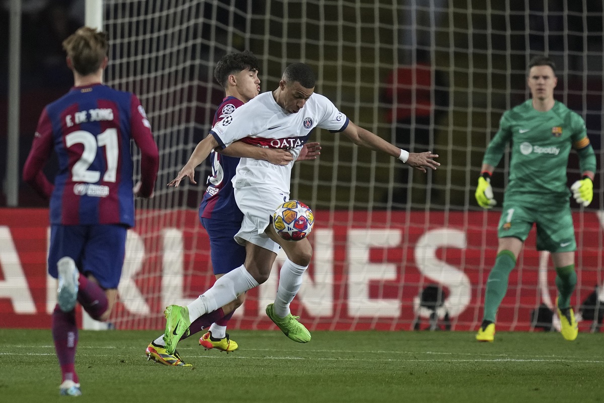PSG's Kylian Mbappe, right, is challenged by Barcelona's Pau Cubarsi during the Champions League quarterfinal second leg soccer match between Barcelona and Paris Saint-Germain at the Olimpic Lluis Companys stadium in Barcelona, Spain, Tuesday, April 16, 2024. (AP Photo/Emilio Morenatti)