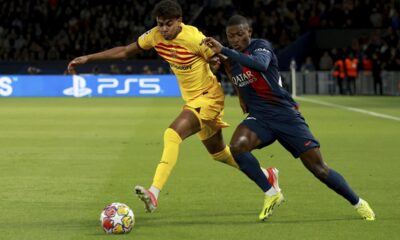 Barcelona's Lamine Yamal fights for the ball with PSG's Nuno Mendes during the Champions League quarterfinal first leg soccer match between Paris Saint-Germain and Barcelona at the Parc des Princes stadium in Paris, Wednesday, April 10, 2024. (AP Photo/Aurelien Morissard)