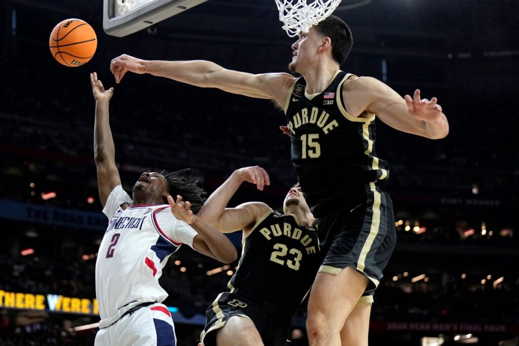Purdue center Zach Edey (15) blockd the shot of UConn guard Tristen Newton during the first half of the NCAA college Final Four championship basketball game, Monday, April 8, 2024, in Glendale, Ariz. (AP Photo/Brynn Anderson)