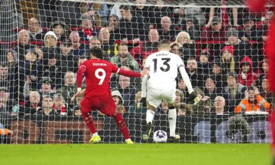 Liverpool's Darwin Nunez, left, scores his side's opening goal during the English Premier League soccer match between Liverpool and Sheffield United at the Anfield stadium in Liverpool, England, Thursday, Apr. 4, 2024. (AP Photo/Jon Super)