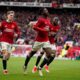 Manchester United's Kobbie Mainoo, centre, celebrates after scoring his side's second goal during the English Premier League soccer match between Manchester United and Liverpool at the Old Trafford stadium in Manchester, England, Sunday, April 7, 2024. (AP Photo/Dave Thompson)