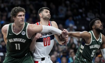 Milwaukee Bucks center Brook Lopez (11) and guard Malik Beasley (5) battle for the rebound position with Washington Wizards forward Tristan Vukcevic (00) during the first half of an NBA basketball game Tuesday, April 2, 2024, in Washington. (AP Photo/Alex Brandon)