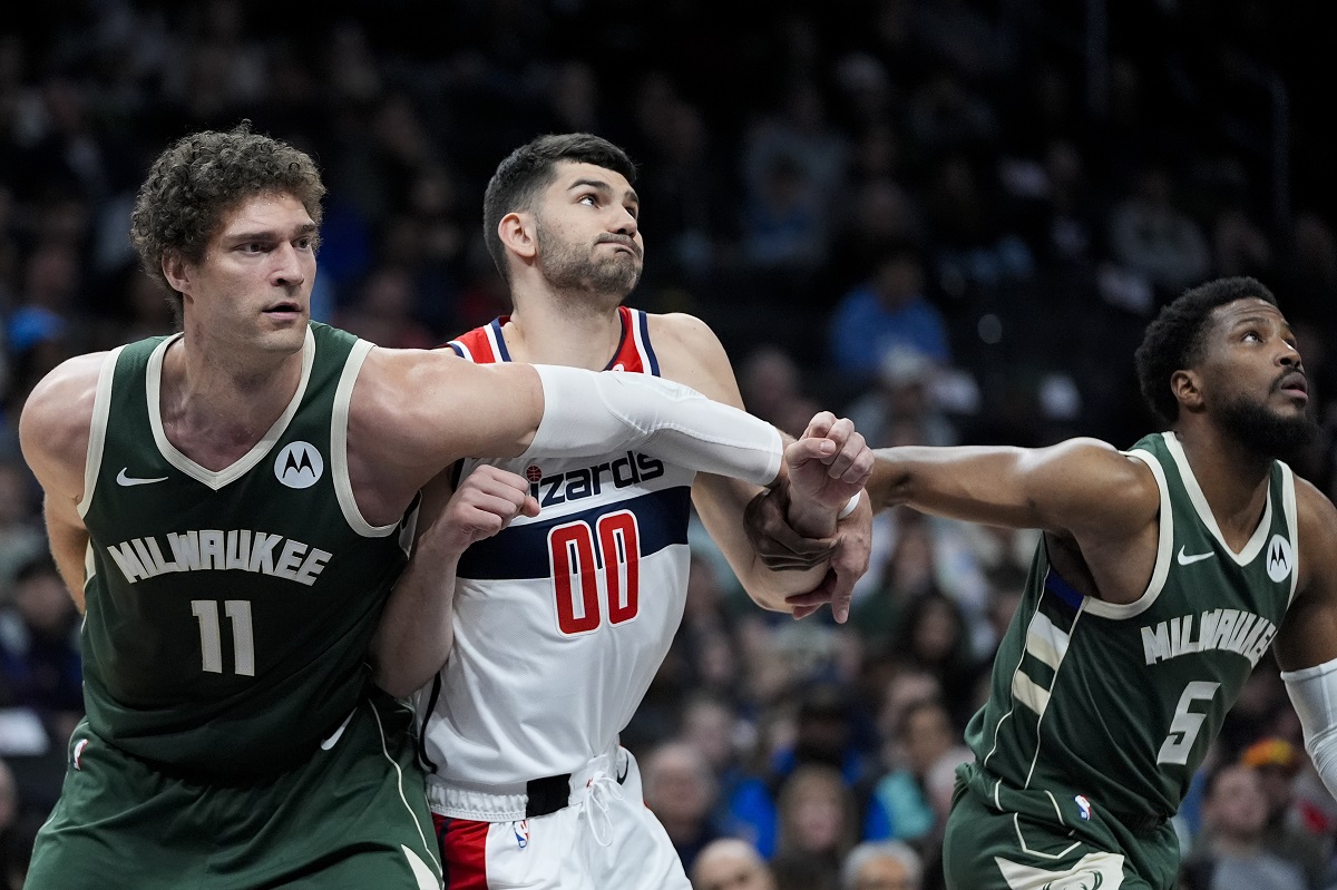 Milwaukee Bucks center Brook Lopez (11) and guard Malik Beasley (5) battle for the rebound position with Washington Wizards forward Tristan Vukcevic (00) during the first half of an NBA basketball game Tuesday, April 2, 2024, in Washington. (AP Photo/Alex Brandon)