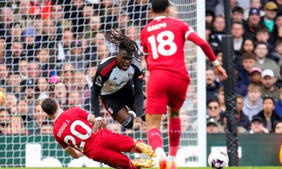 Fulham's Alex Iwobi, center top, duels for the ball with Liverpool's Diogo Jota during the English Premier League soccer match between Fulham and Liverpool at Craven Cottage stadium in London, Sunday, April 21, 2024. (AP Photo/Kirsty Wigglesworth)