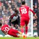 Fulham's Alex Iwobi, center top, duels for the ball with Liverpool's Diogo Jota during the English Premier League soccer match between Fulham and Liverpool at Craven Cottage stadium in London, Sunday, April 21, 2024. (AP Photo/Kirsty Wigglesworth)