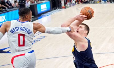 Denver Nuggets center Nikola Jokic, right, tries to shoot as Los Angeles Clippers guard Russell Westbrook fouls him during the second half of an NBA basketball game Thursday, April 4, 2024, in Los Angeles. (AP Photo/Mark J. Terrill)
