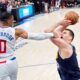 Denver Nuggets center Nikola Jokic, right, tries to shoot as Los Angeles Clippers guard Russell Westbrook fouls him during the second half of an NBA basketball game Thursday, April 4, 2024, in Los Angeles. (AP Photo/Mark J. Terrill)