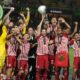 Olympiacos' Kostas Fortounis, center, raises the Conference League trophy as he celebrates with his teammates at the end of the Conference League final soccer match between Olympiacos FC and ACF Fiorentina at OPAP Arena in Athens, Greece, Thursday, May 30, 2024. Olympiacos won 1-0. (AP Photo/Thanassis Stavrakis)