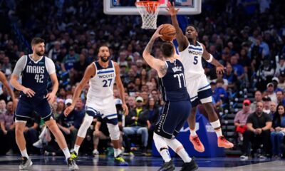 Dallas Mavericks guard Luka Doncic (77) shoots against Minnesota Timberwolves guard Anthony Edwards (5) during the first half in Game 4 of the NBA basketball Western Conference finals, Tuesday, May 28, 2024, in Dallas. (AP Photo/Julio Cortez)
