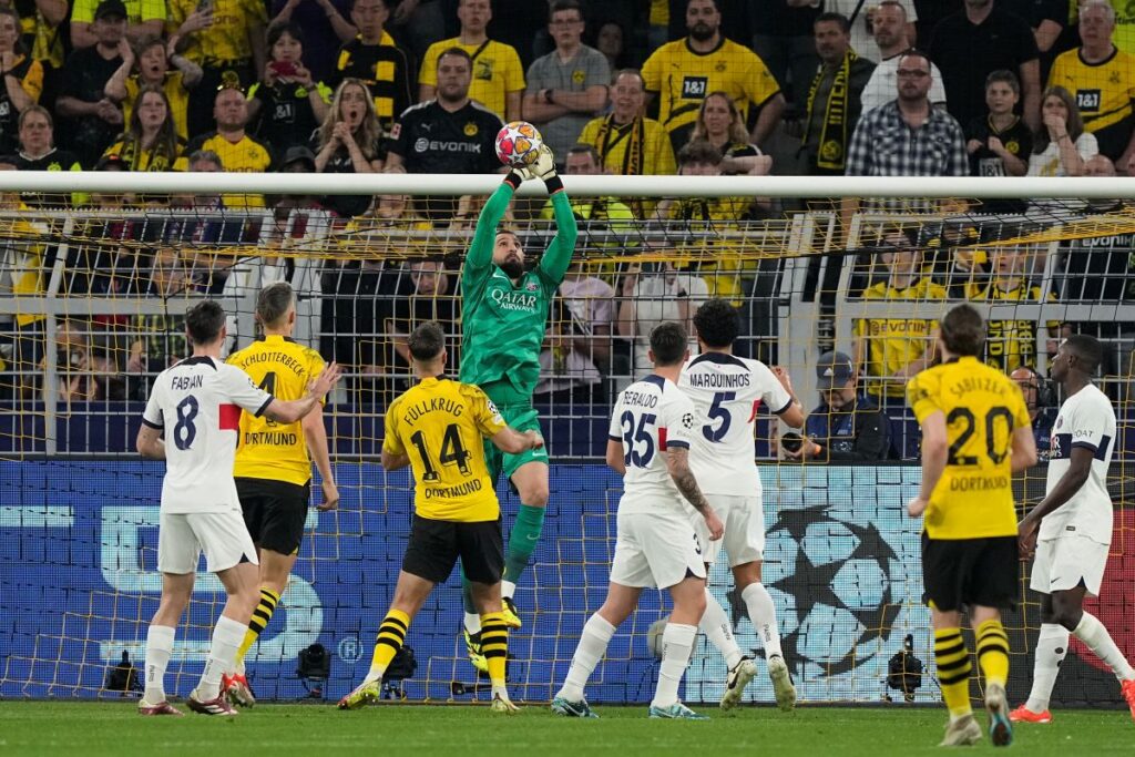 PSG's goalkeeper Gianluigi Donnarumma, top, catches the ball during the Champions League semifinal first leg soccer match between Borussia Dortmund and Paris Saint-Germain at the Signal-Iduna Park in Dortmund, Germany, Wednesday, May 1, 2024. (AP Photo/Martin Meissner)