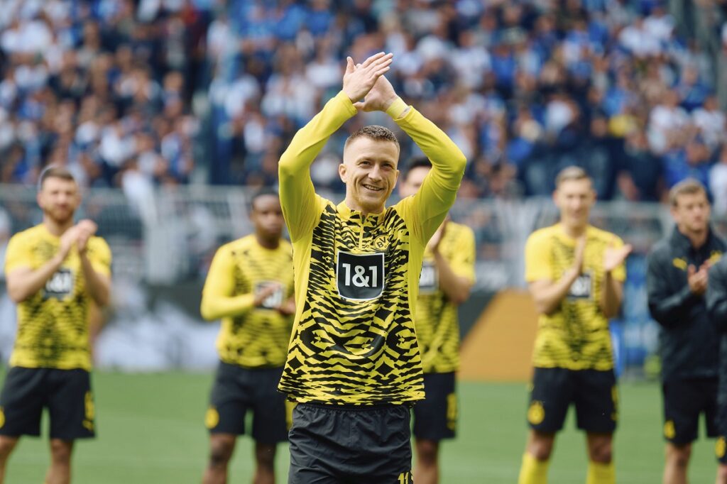 Dortmund's Marco Reus is congratulated before the Bundesliga soccer match between Borussia Dortmund and SV Darmstadt 98 at the Signal Iduna Park in Dortmund, Germany, Saturday May 18, 2024. This is last game of Marco Reus with Dortmund. Photo: Bernd Thissen/dpa - IMPORTANT NOTE: In accordance with the regulations of the DFL German Football League and the DFB German Football Association, it is prohibited to utilize or have utilized photographs taken in the stadium and/or of the match in the form of sequential images and/or video-like photo series./dpa via AP)