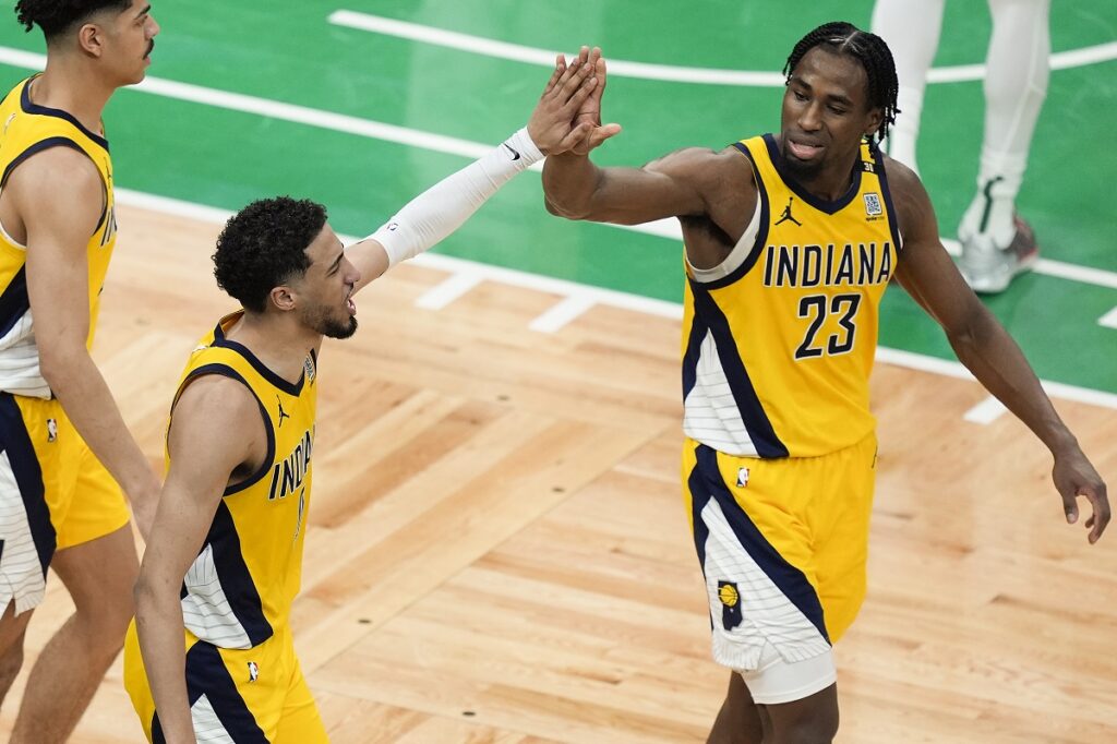 Indiana Pacers guard Tyrese Haliburton (0) high fives Indiana Pacers forward Aaron Nesmith (23) during the third quarter of Game 1 of the NBA Eastern Conference basketball finals, Tuesday, May 21, 2024, in Boston. (AP Photo/Michael Dwyer)