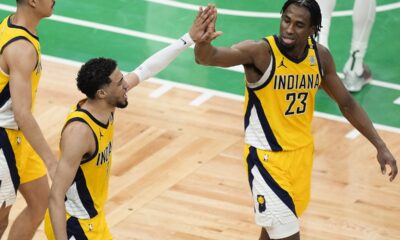 Indiana Pacers guard Tyrese Haliburton (0) high fives Indiana Pacers forward Aaron Nesmith (23) during the third quarter of Game 1 of the NBA Eastern Conference basketball finals, Tuesday, May 21, 2024, in Boston. (AP Photo/Michael Dwyer)