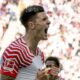 Leipzig's Benjamin Sesko celebrates after scoring his side's first goal during German Bundesliga soccer match between RB Leipzig and Werder Bremen in Leipzig, Germany, Saturday, May 11, 2024. (Hendrik Schmidt/dpa via AP)
