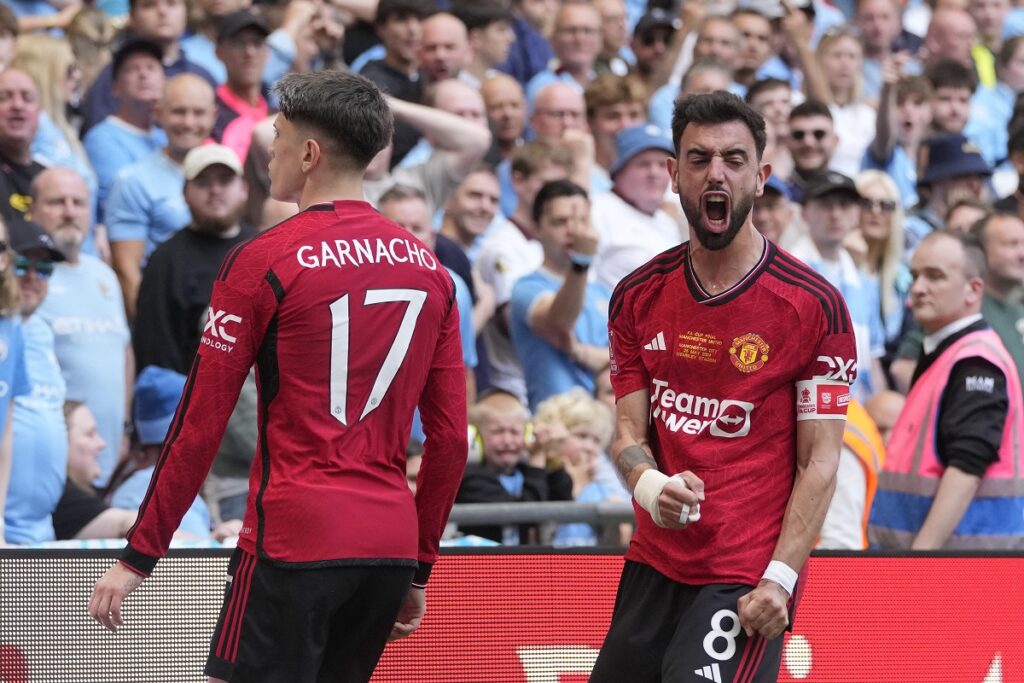 Manchester United's Alejandro Garnacho, left, celebrates after scoring his side's opening goal with his teammate Bruno Fernandes during the English FA Cup final soccer match between Manchester City and Manchester United at Wembley Stadium in London, Saturday, May 25, 2024. (AP Photo/Kin Cheung)