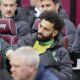 Liverpool's Mohamed Salah sits on the substitute bench ahead of the English Premier League match between West Ham United and Liverpool, at London stadium, in London, Saturday April 27, 2024. (Jonathan Brady/PA via AP)