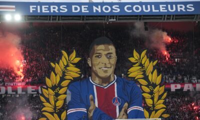 A giant painting depicting PSG's Kylian Mbappe is displayed before the French League One soccer match between Paris Saint-Germain and Toulouse at the Parc des Princes stadium in Paris, Sunday, May 12, 2024. (AP Photo/Christophe Ena)