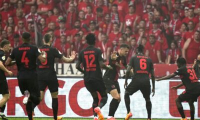 Leverkusen's Granit Xhaka, center, celebrates with team mates after scoring his side's opening goal during the German Soccer Cup final match between 1. FC Kaiserslautern and Bayer Leverkusen at the Olympic Stadium in Berlin, Germany, Saturday, May 25, 2024. (AP Photo/Matthias Schrader)