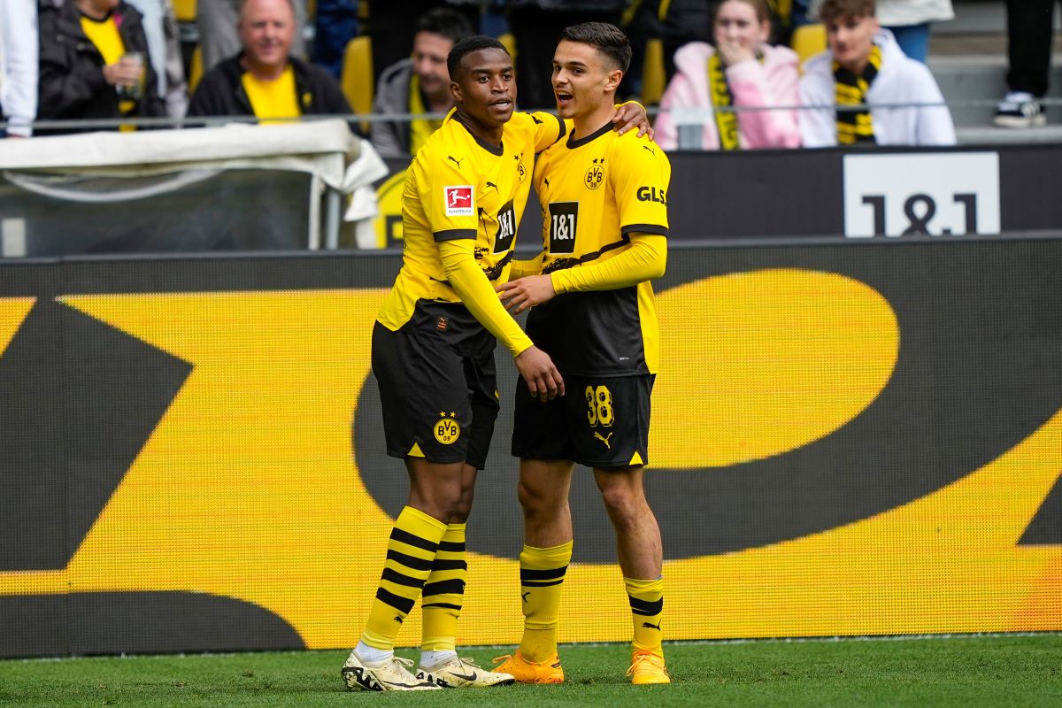 Dortmund's Youssoufa Moukoko, leftt, celebrates with his teammate Watjen Kjell-Arik after he scored his side's first goal during the German Bundesliga soccer match between Borussia Dortmund and Augsburg, in Dortmund, Saturday, May 4, 2024. (AP Photo/Martin Meissner)