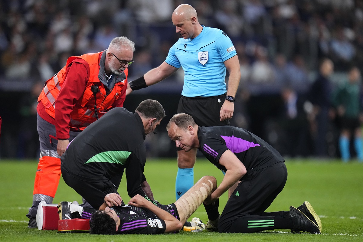 Bayern's Aleksandar Pavlovic receives treatment from medical staff during the Champions League semifinal second leg soccer match between Real Madrid and Bayern Munich at the Santiago Bernabeu stadium in Madrid, Spain, Wednesday, May 8, 2024. (AP Photo/Manu Fernandez)