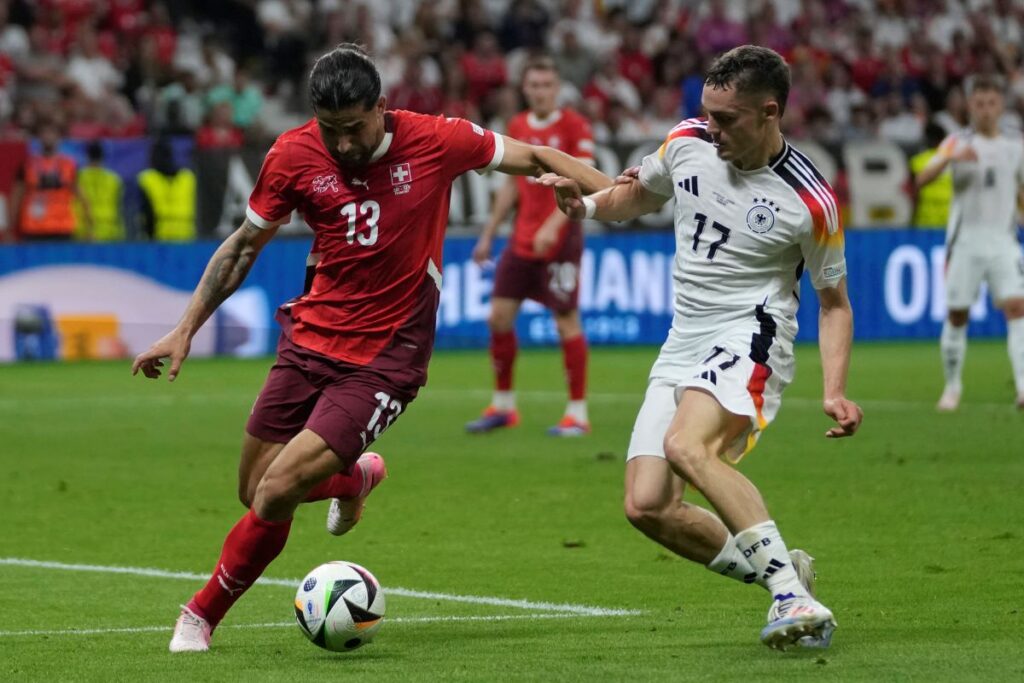 Germany's Florian Wirtz, right, challenges Switzerland's Ricardo Rodriguez during a Group A match between Switzerland and Germany at the Euro 2024 soccer tournament in Frankfurt, Germany, Sunday, June 23, 2024. (AP Photo/Darko Vojinovic)